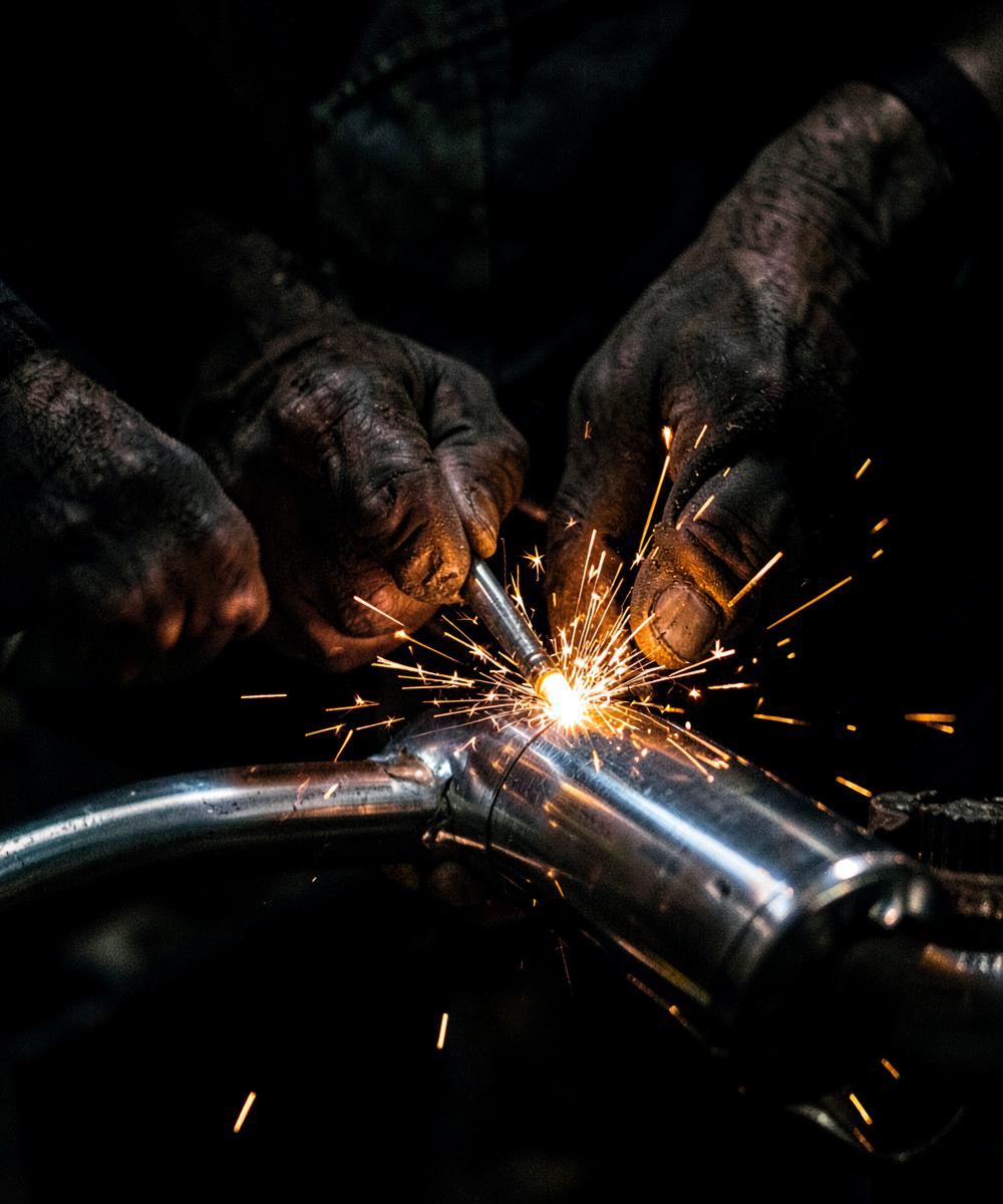 Craftsman TIG welding a stainless steel exhaust
